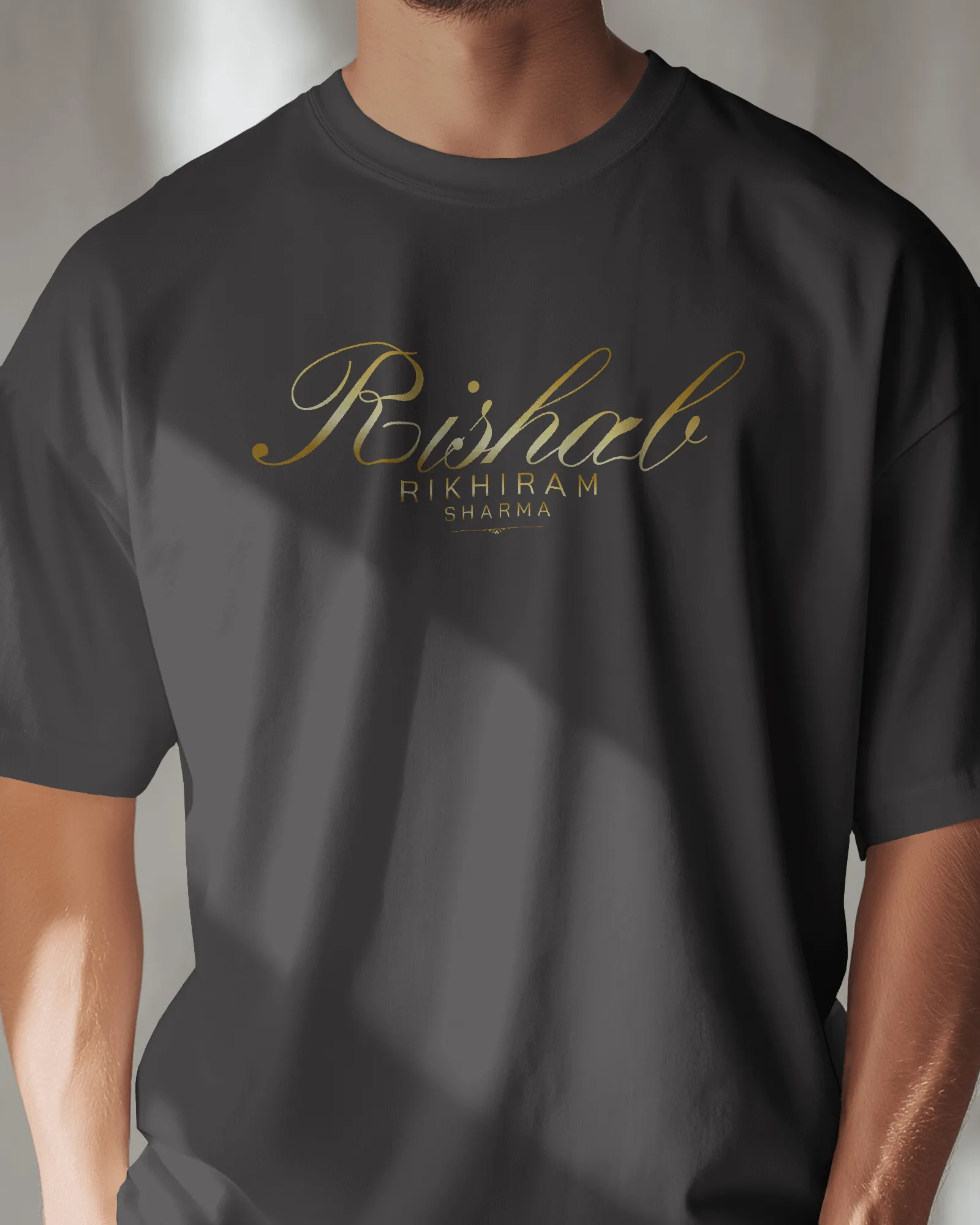 ["Premium Hand Printed Oversized 'Rishab Rikhiram Sharma' Gold Script T-shirt by YORD (T-Shirts) - photo 1 of 9", "Premium Hand Printed Oversized 'Rishab Rikhiram Sharma' Gold Script T-shirt by YORD (T-Shirts) - photo 2 of 9", "Premium Hand Printed Oversized 'Rishab Rikhiram Sharma' Gold Script T-shirt by YORD (T-Shirts) - photo 3 of 9", "Premium Hand Printed Oversized 'Rishab Rikhiram Sharma' Gold Script T-shirt by YORD (T-Shirts) - photo 4 of 9", "Premium Hand Printed Oversized 'Rishab Rikhiram Sharma' Go
